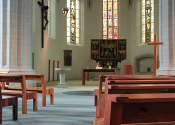 St. Petri-Pauli-Kirche - Altarraum mit in den Boden eingelassenes Taufbecken und Holzbänken